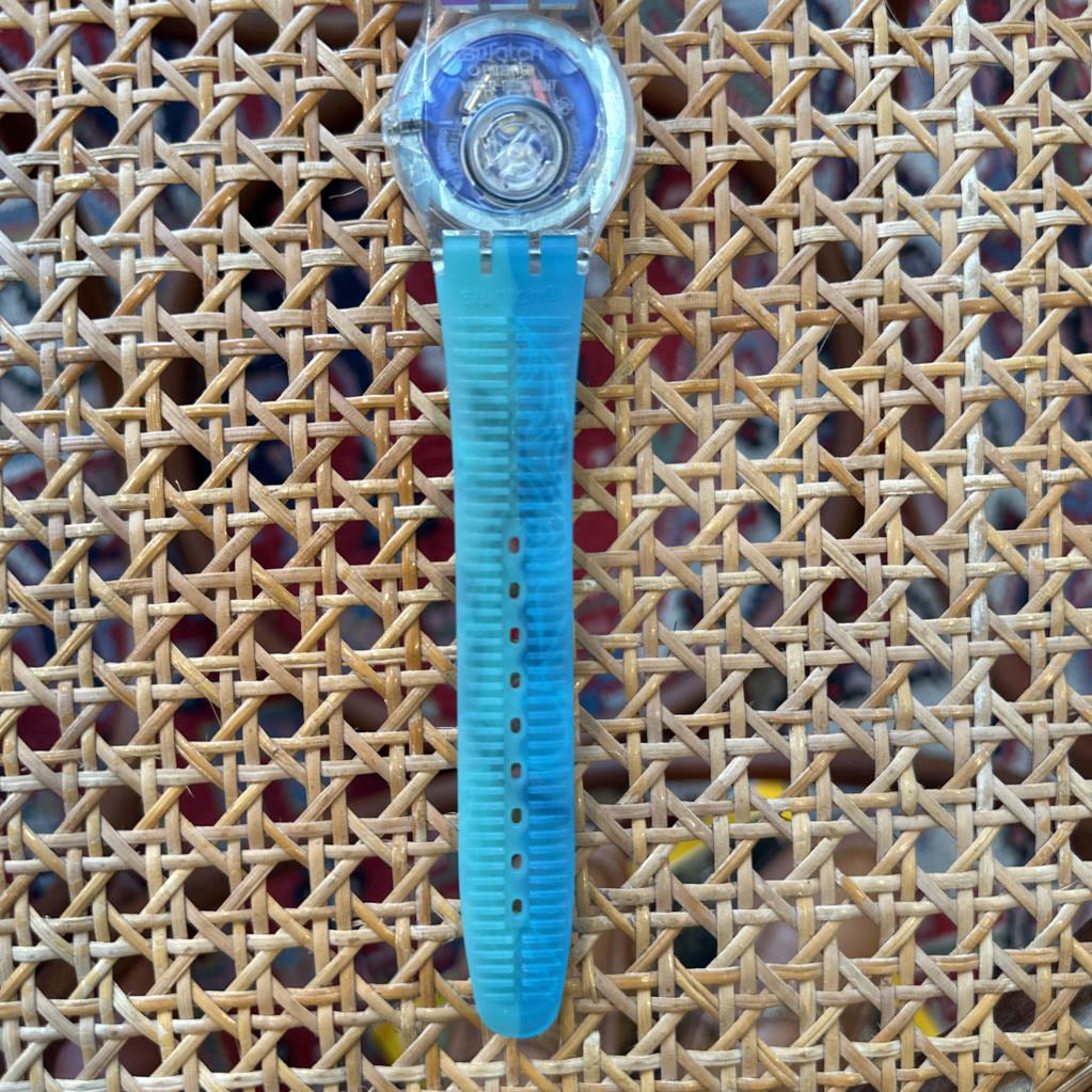 Blue jelly watch on a textured woven surface