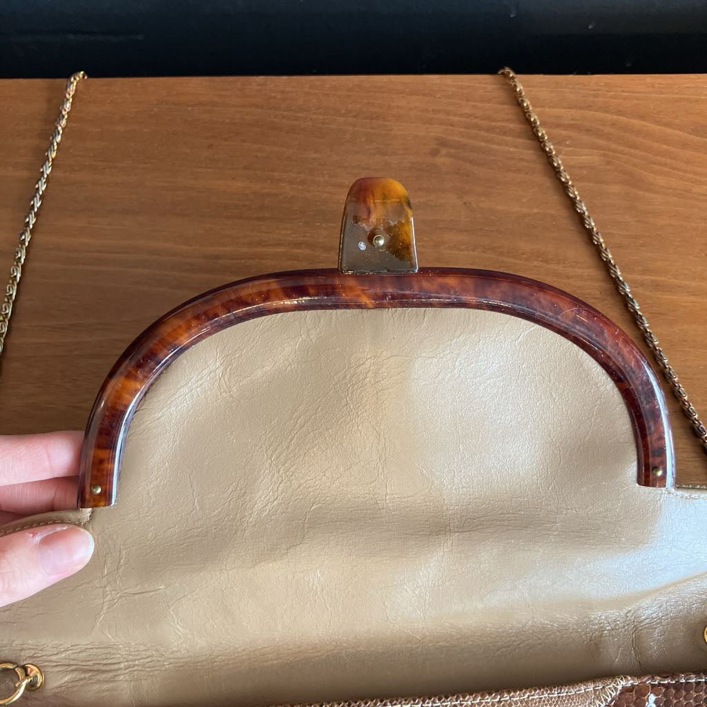 Close up of lucite clasp with a wooden background