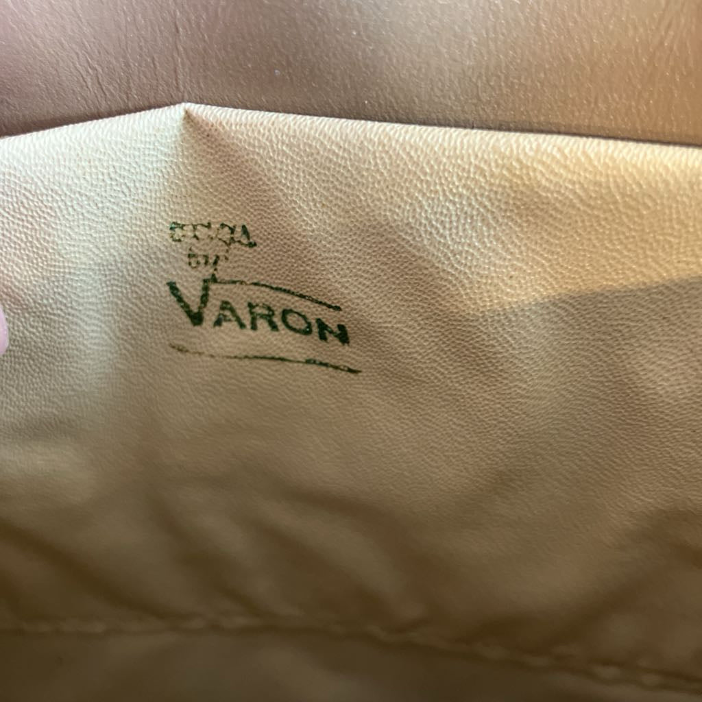 Beige leather product with 'Varon' branding in green text.