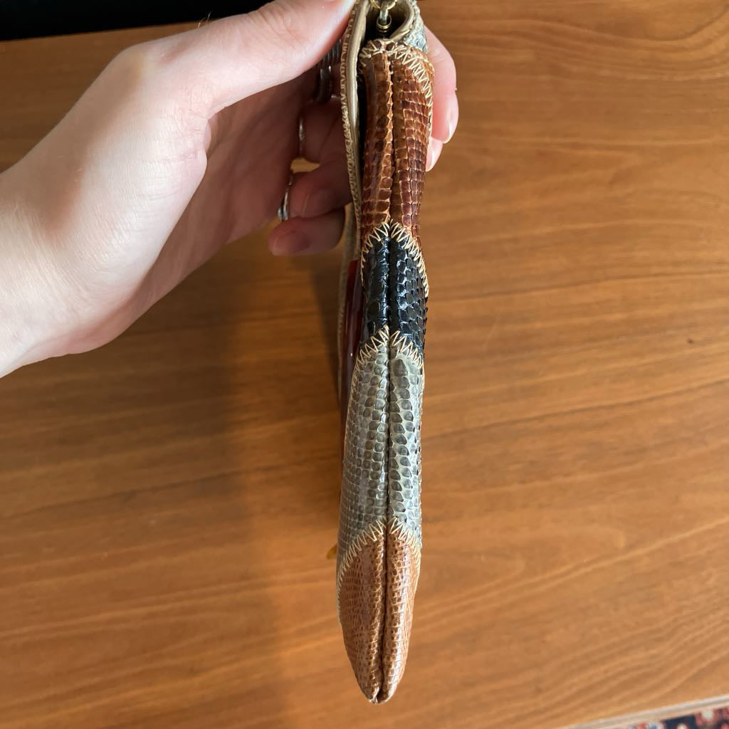 Hand holding a textured object against a wooden surface