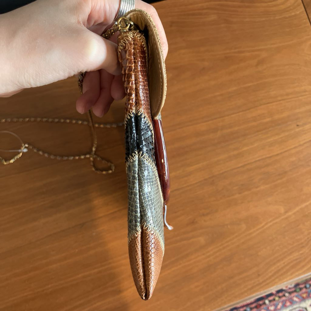 Hand holding a textured bag with a wooden surface in the background