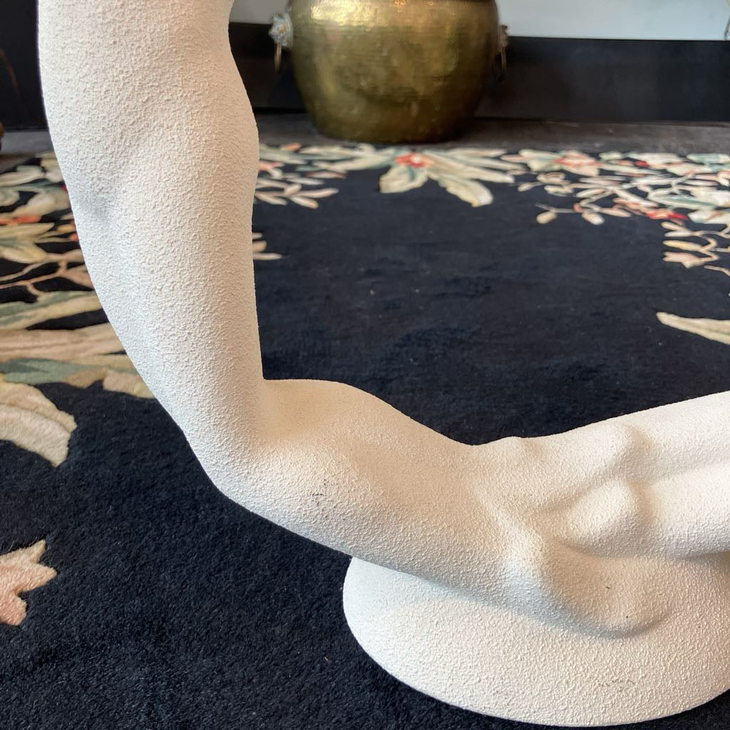 Close-up of a textured white sculpture with a blurred background