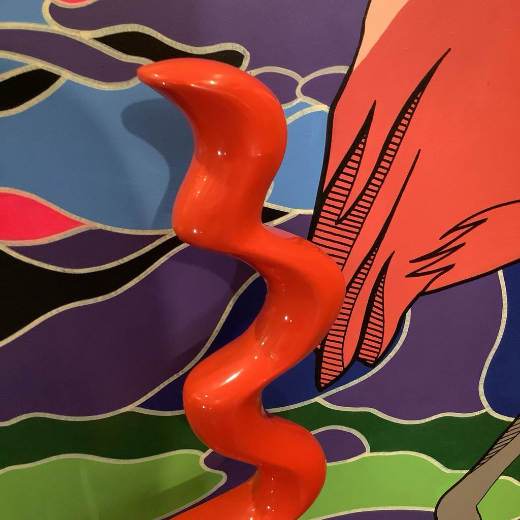 Abstract artwork with a red wavy object against a colorful background