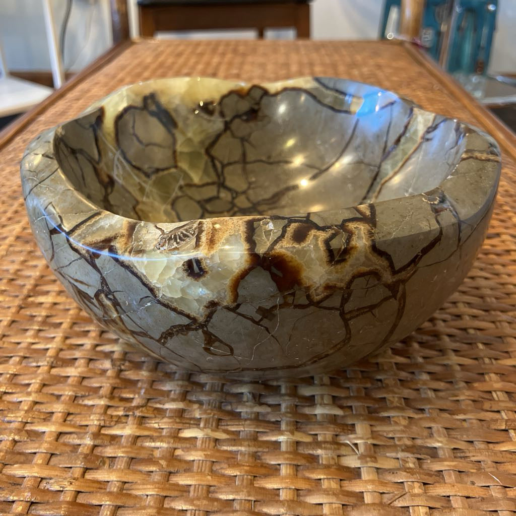 Decorative bowl with a unique pattern on a woven surface