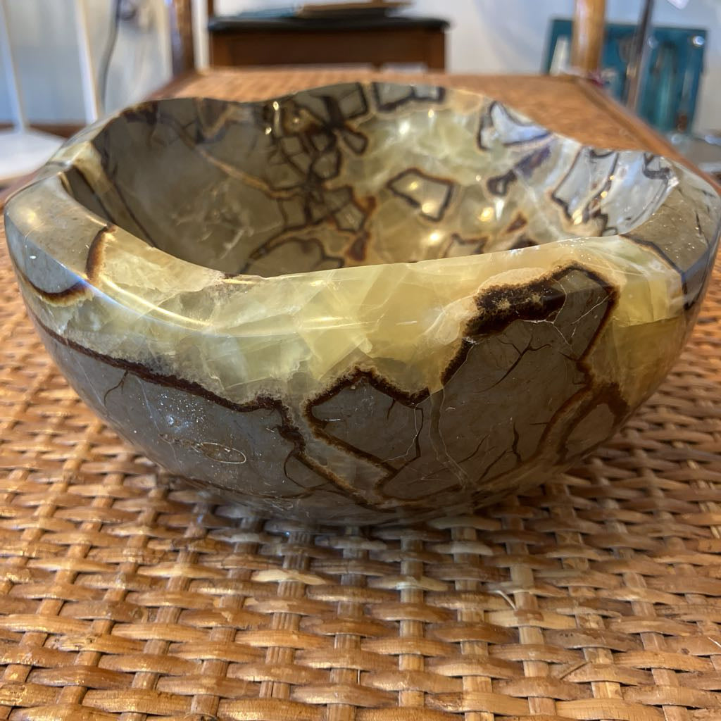 Decorative stone bowl on a woven surface