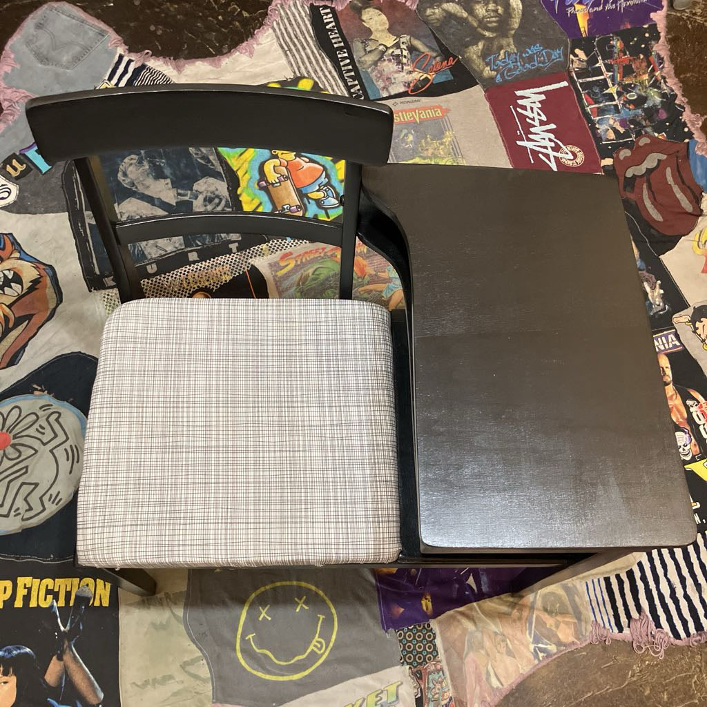 Black table and white cushion on a colorful surface with graphic designs