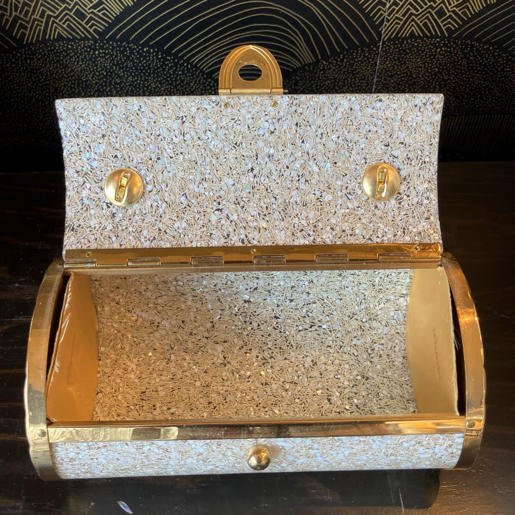 Gold and silver clutch bag on a dark background