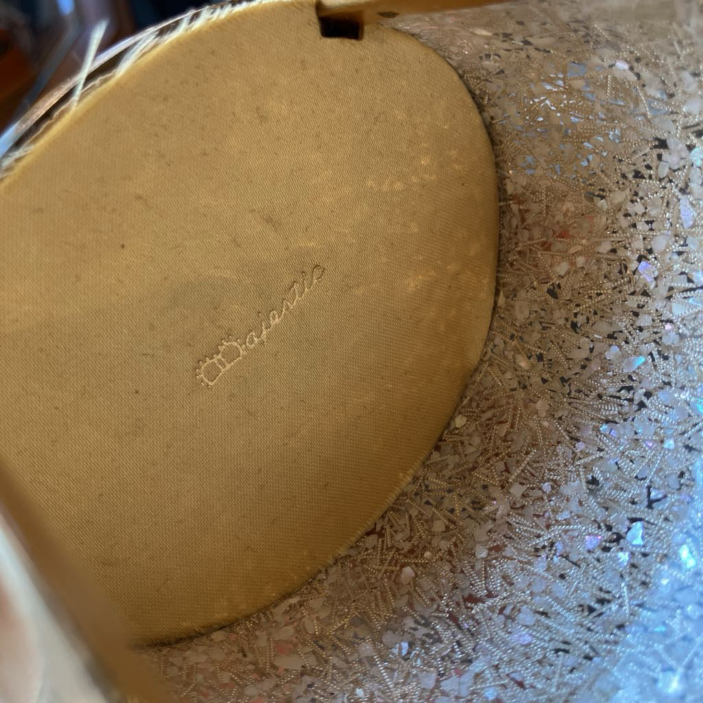 Round interior sides of bag with the name "Majestic" embossed in gold.