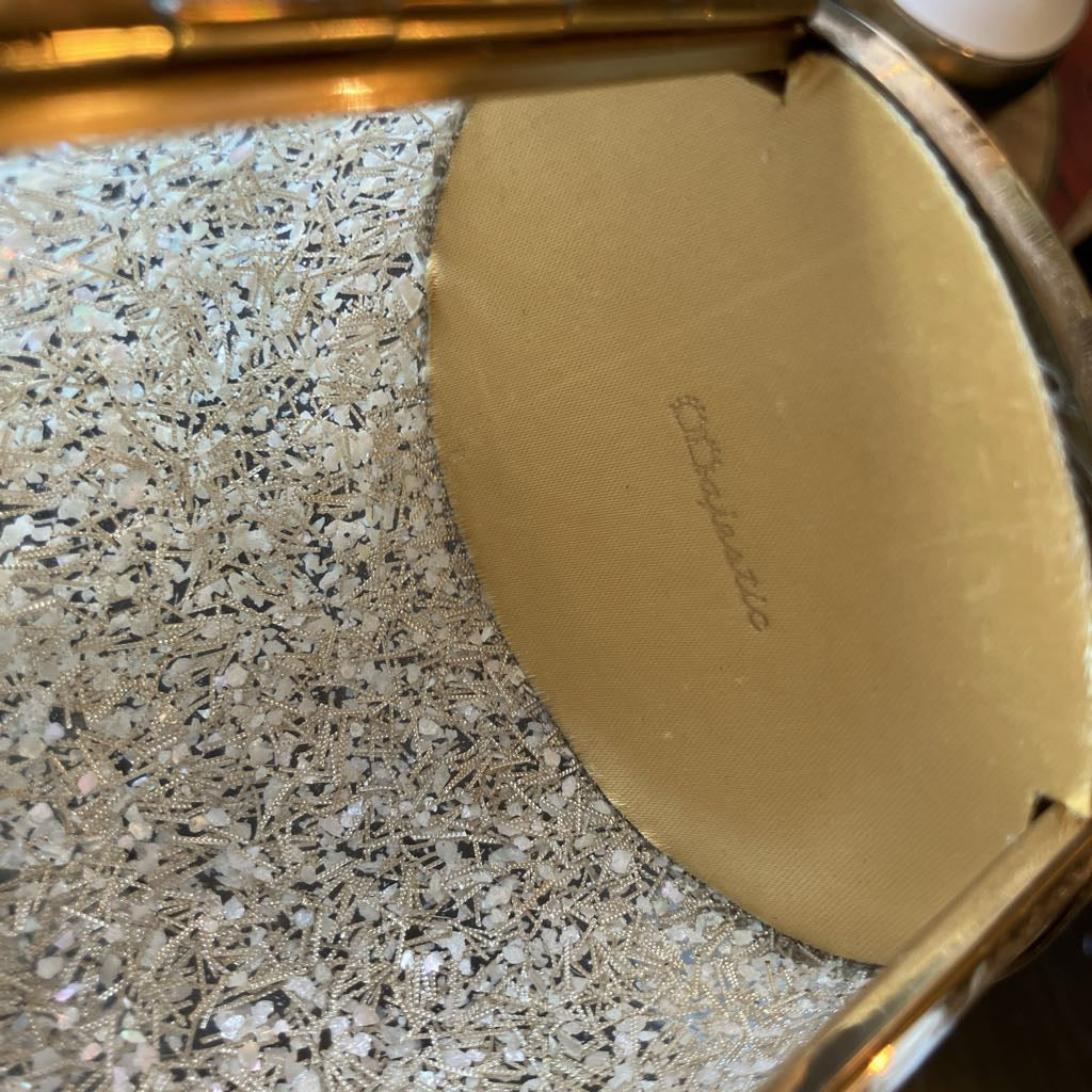 Round interior sides of bag with the name "Majestic" embossed in gold.