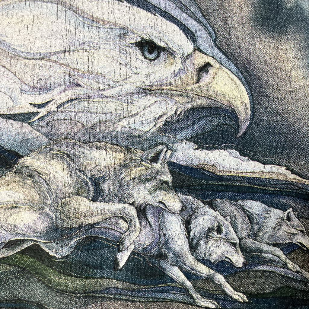 Artistic depiction of an eagle with wolves in a landscape