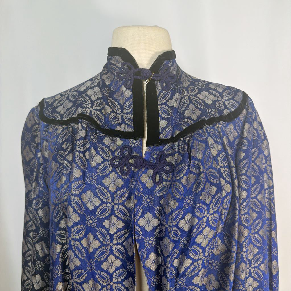 Blue and silver patterned garment on a mannequin against a white background