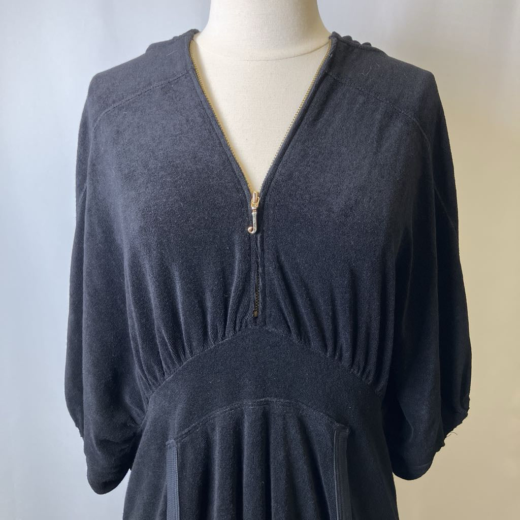 Black terry cloth dress on a mannequin against a plain background