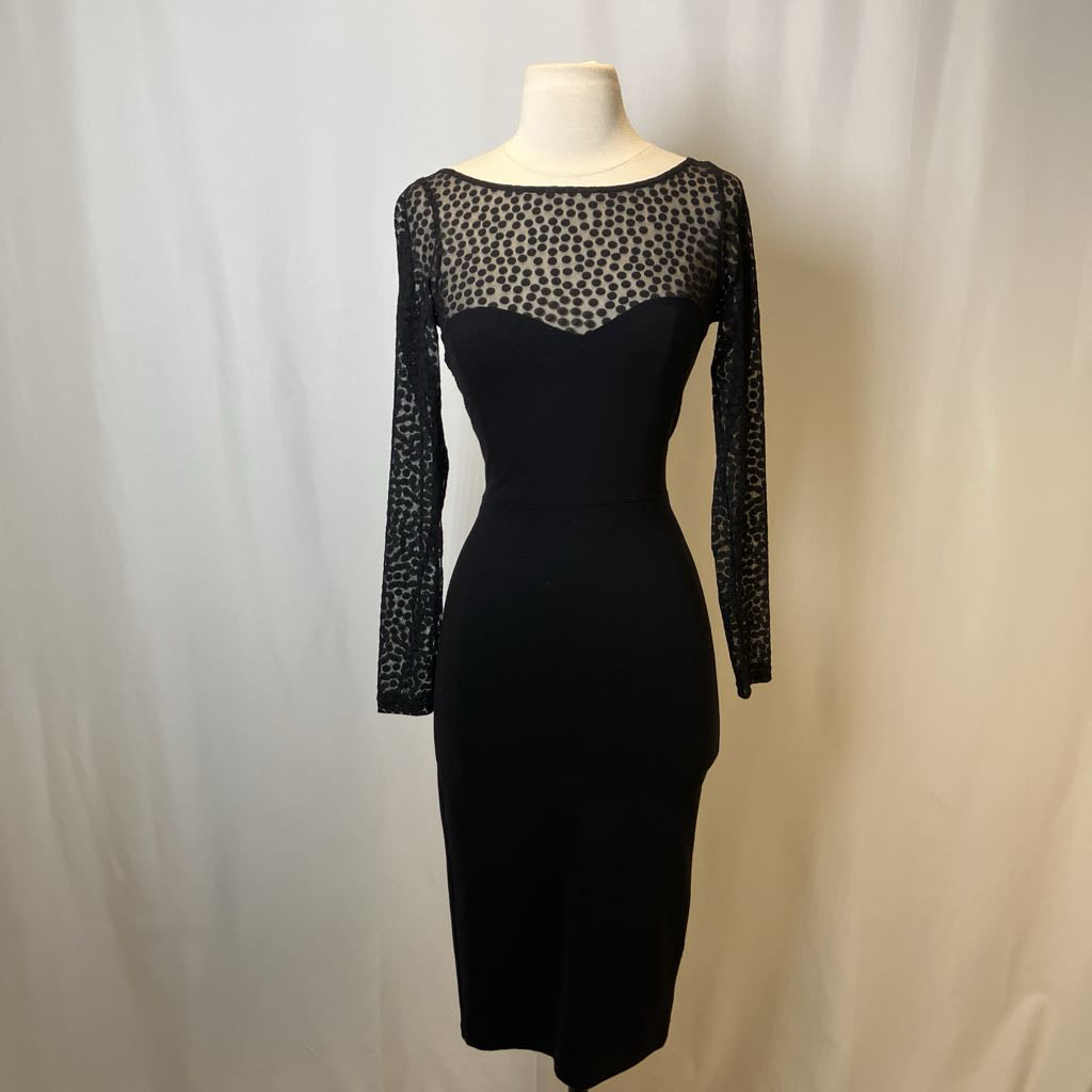 Black dress with sheer long-sleeve top on a mannequin against a white background