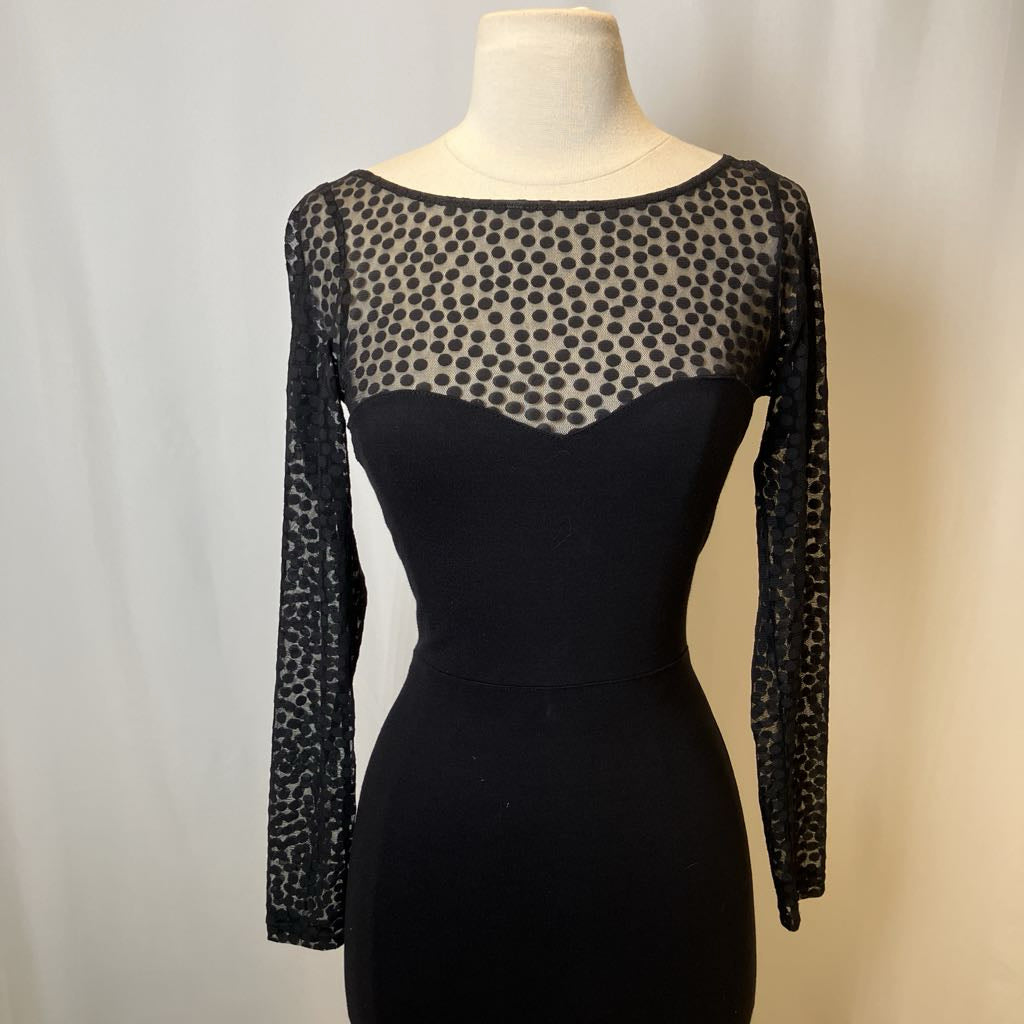 Black dress with sheer leopard print sleeves on a mannequin against a neutral background
