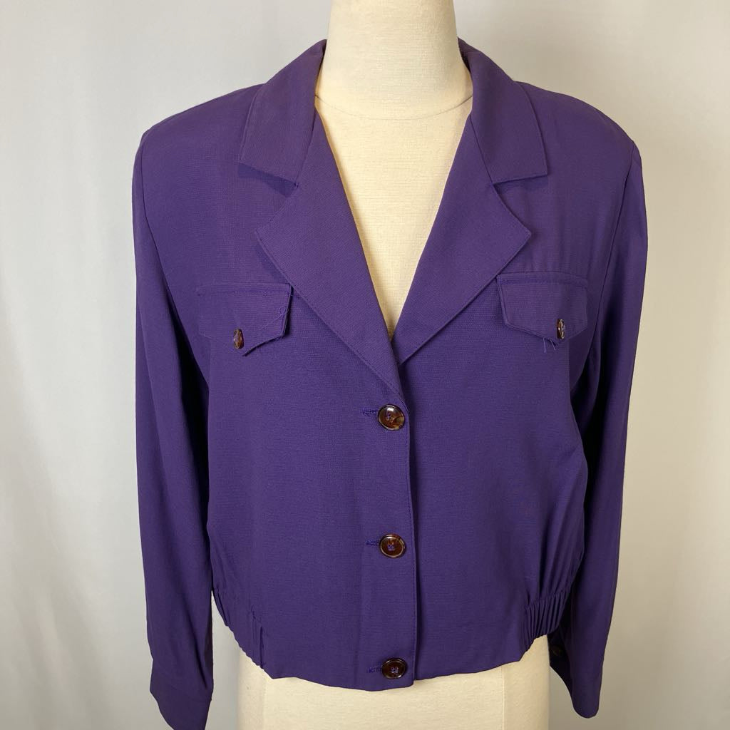 Purple jacket on a mannequin against a plain background