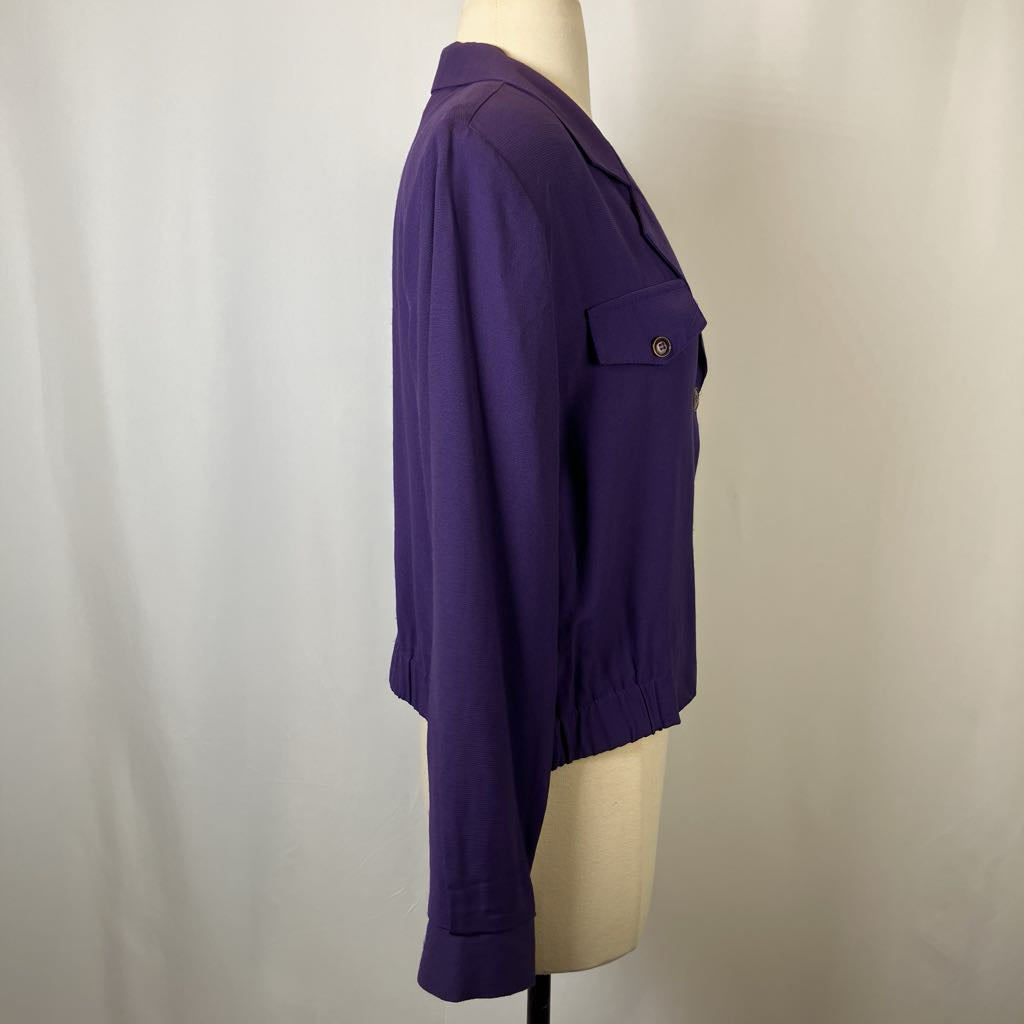 Purple shirt on a mannequin against a plain background