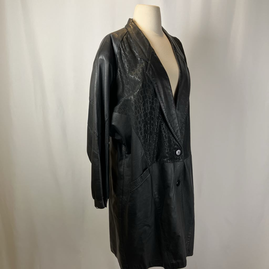 Black textured coat on a mannequin against a plain background