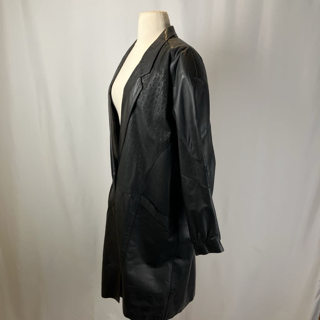Black leather jacket on a mannequin against a plain background