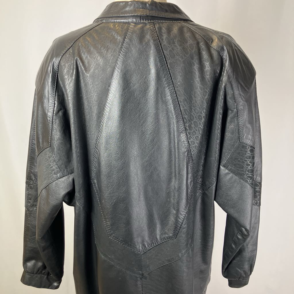 Back view of a black leather jacket on a plain background