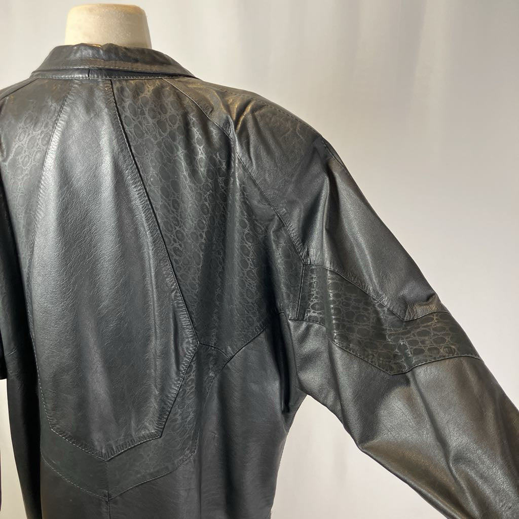 Black leather jacket on a mannequin against a plain background