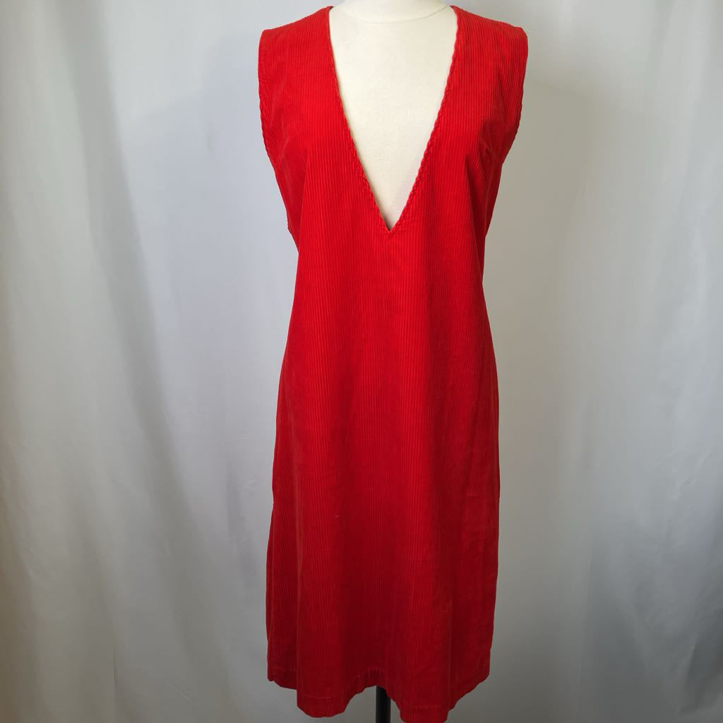 Red sleeveless dress on a mannequin against a plain background