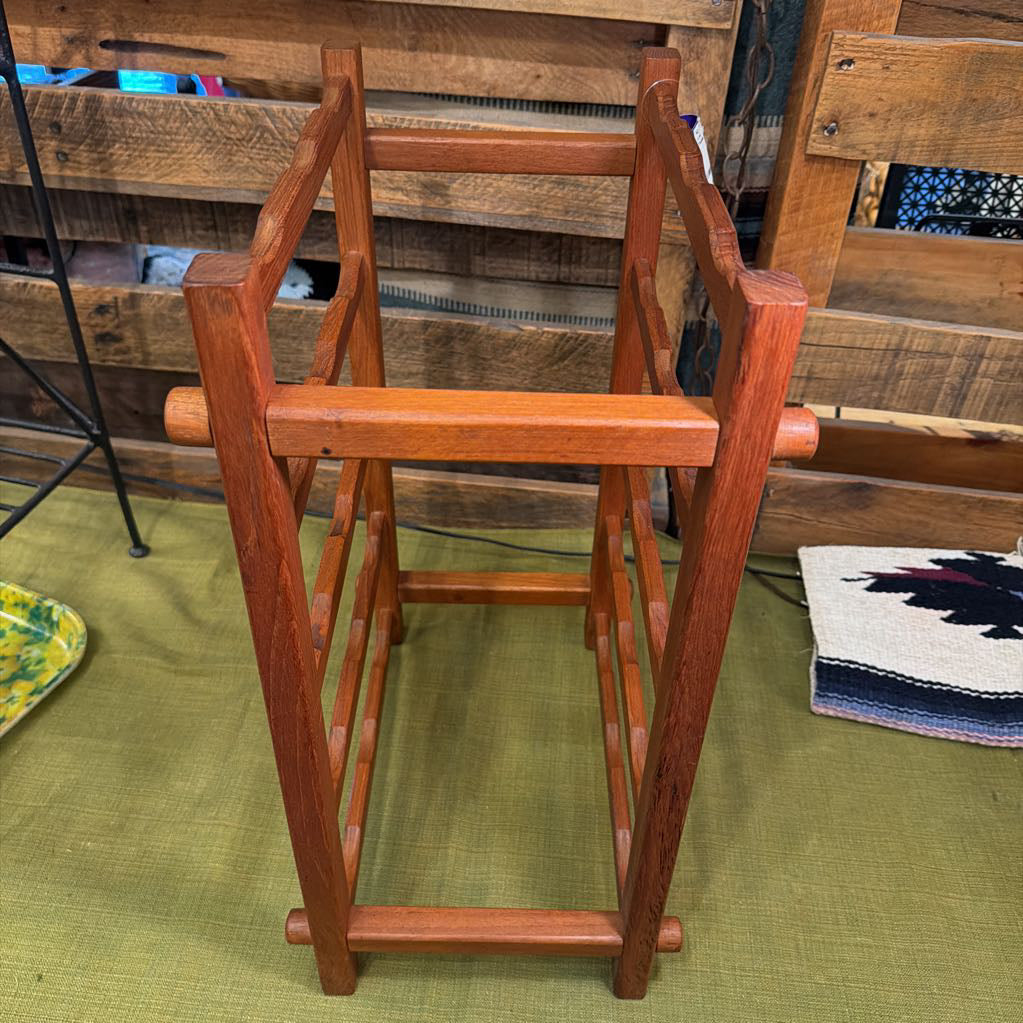 Wooden rack against a wooden wall with a green floor