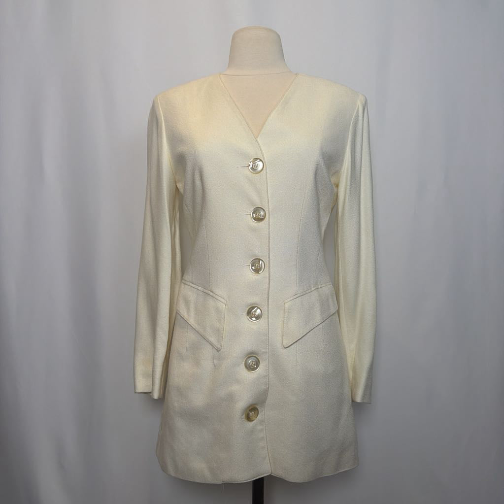 White blazer on a mannequin against a plain background