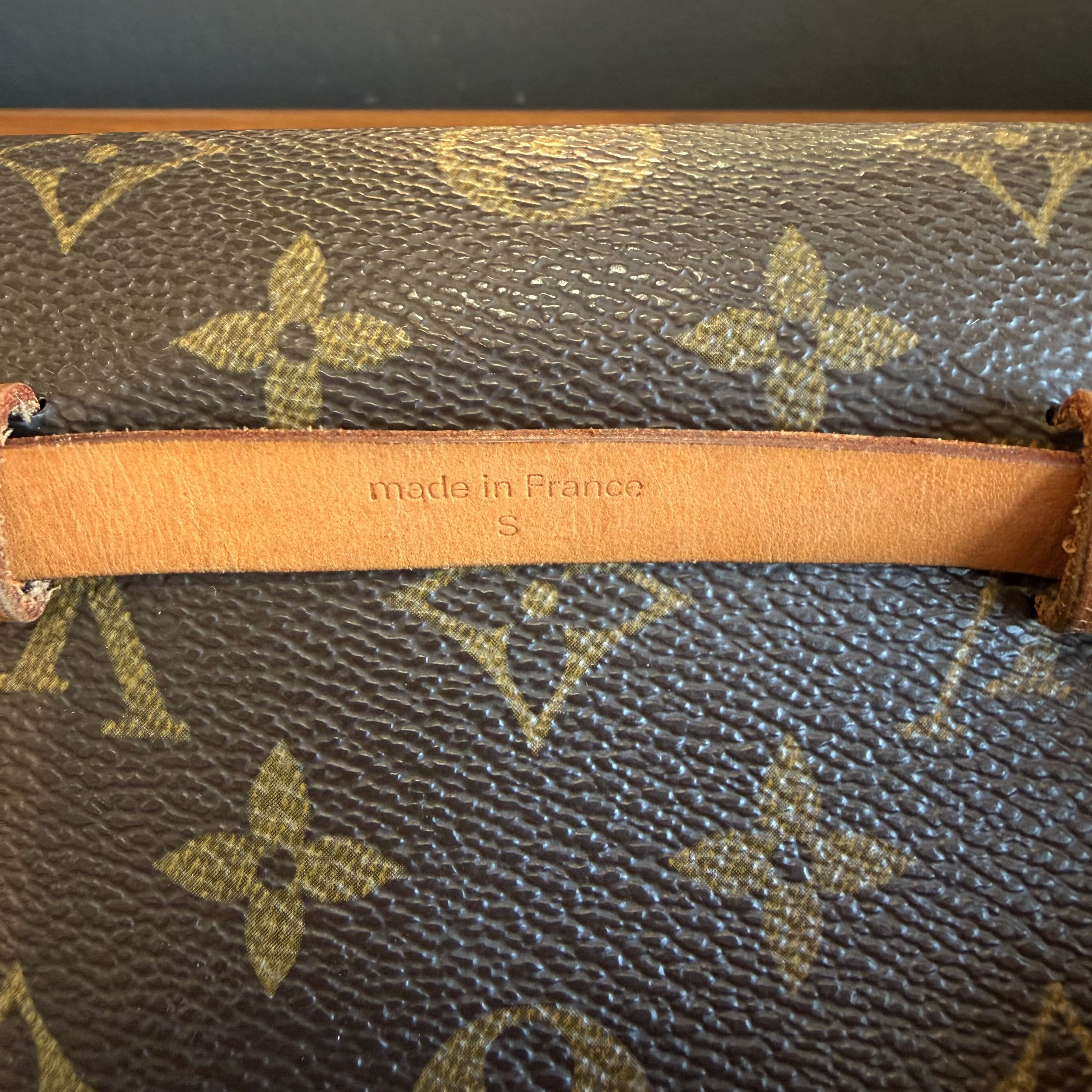 Close-up of a Louis Vuitton monogram handbag with 'made in France' label.