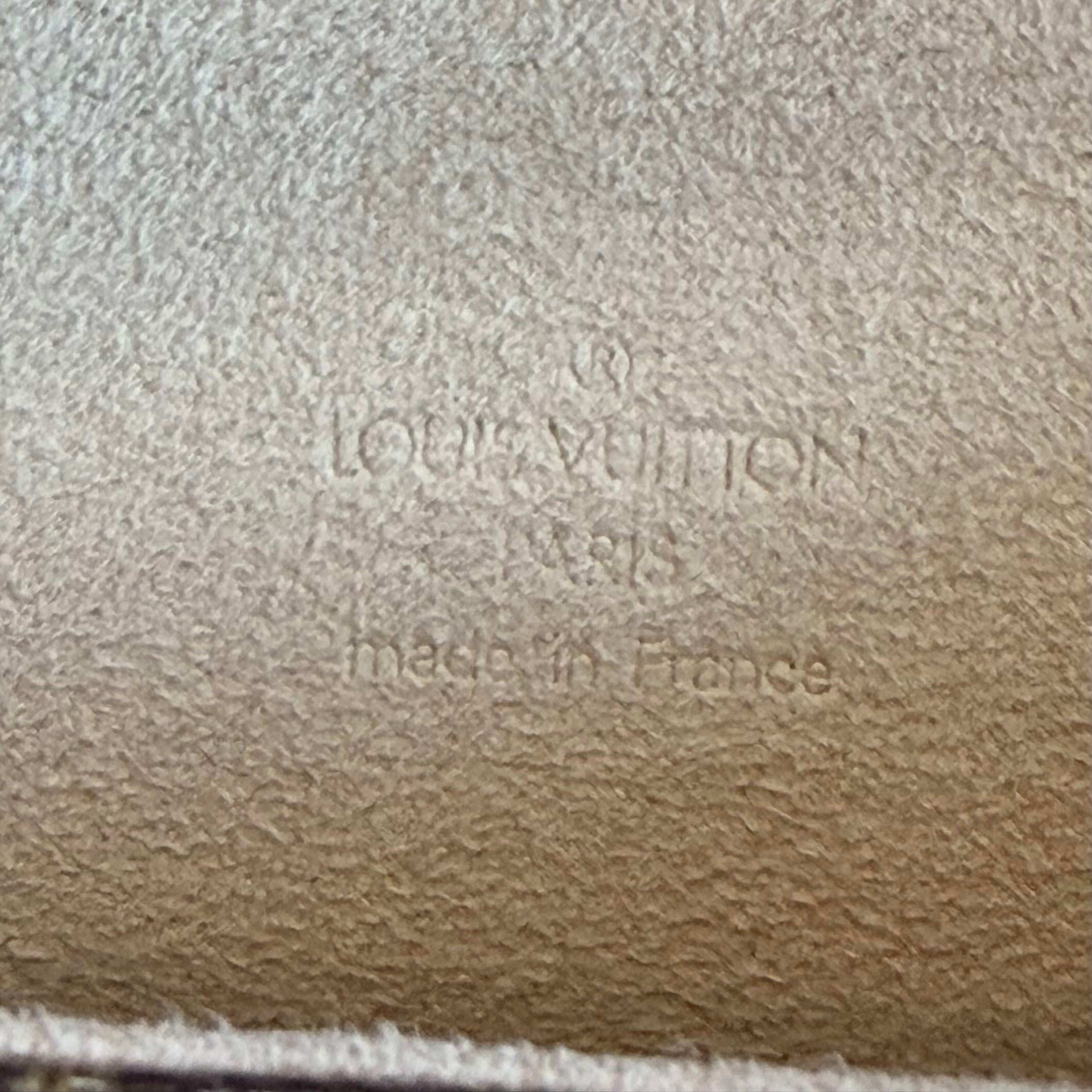 Louis Vuitton logo embossed on a textured surface