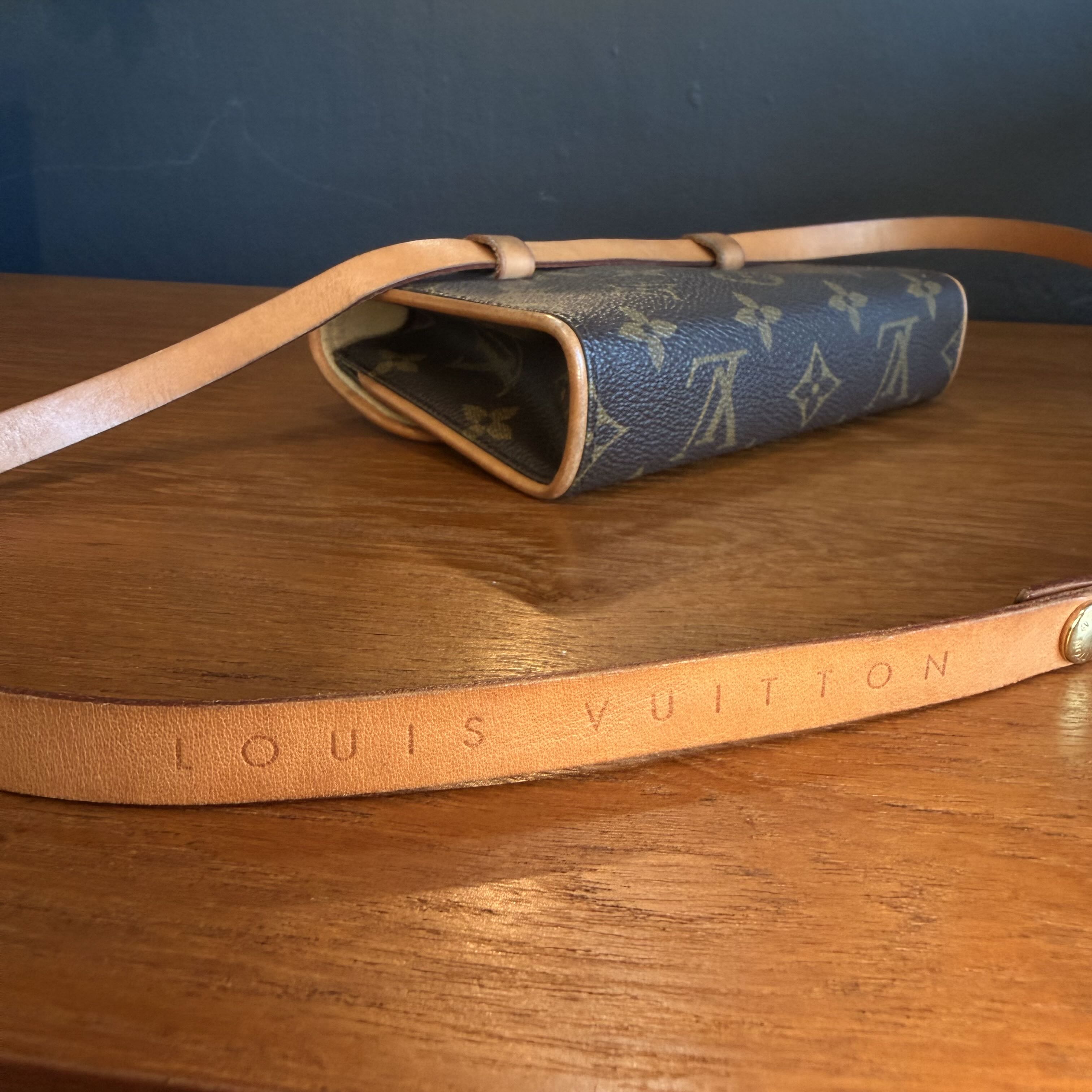 Louis Vuitton handbag with monogram pattern on a wooden surface