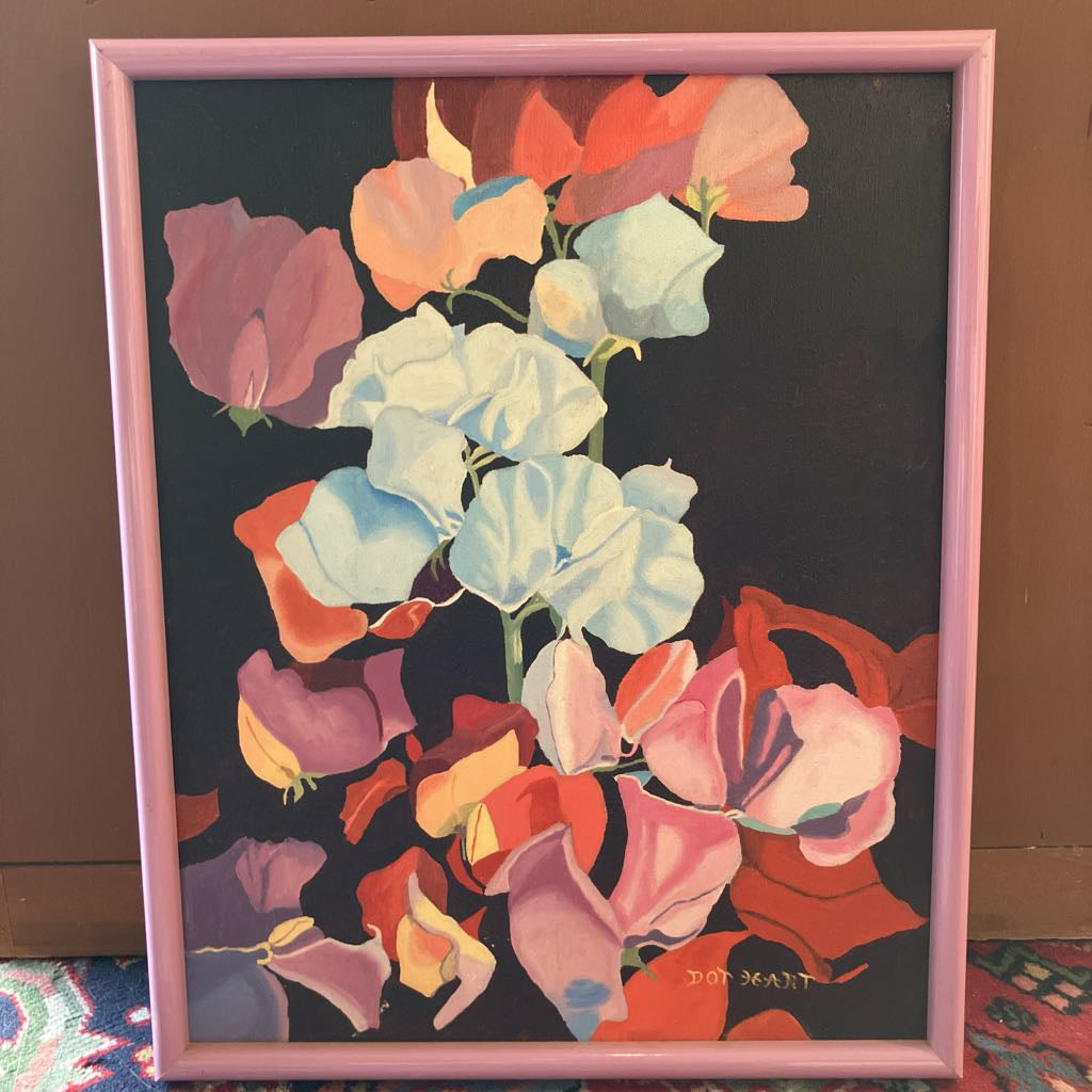 Framed artwork of colorful flowers on a dark background