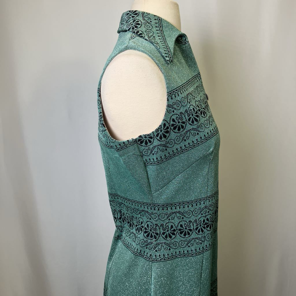 Green sleeveless dress with black pattern on a mannequin against a neutral background