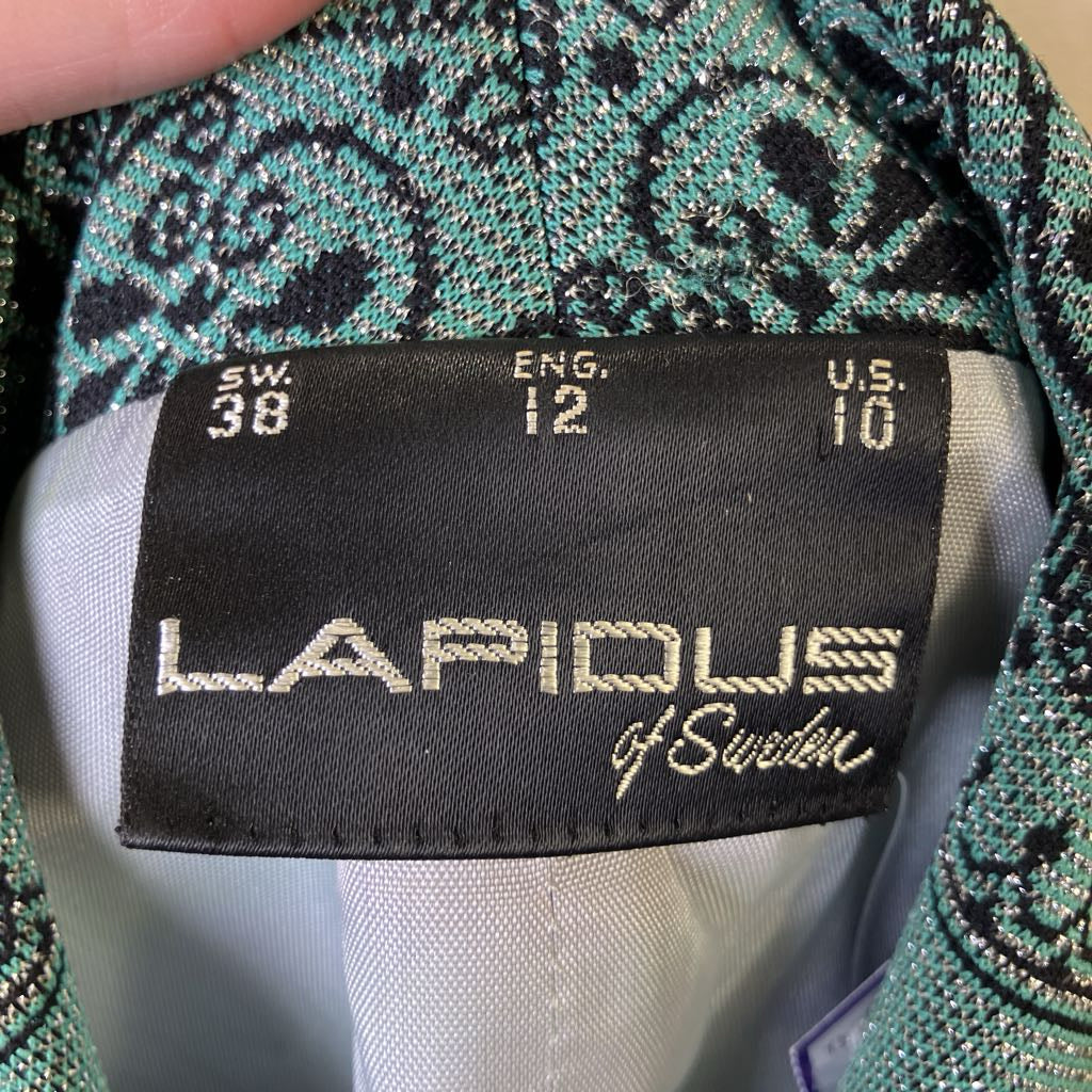 Clothing label with 'Lapidus of Sweden' on a patterned fabric background