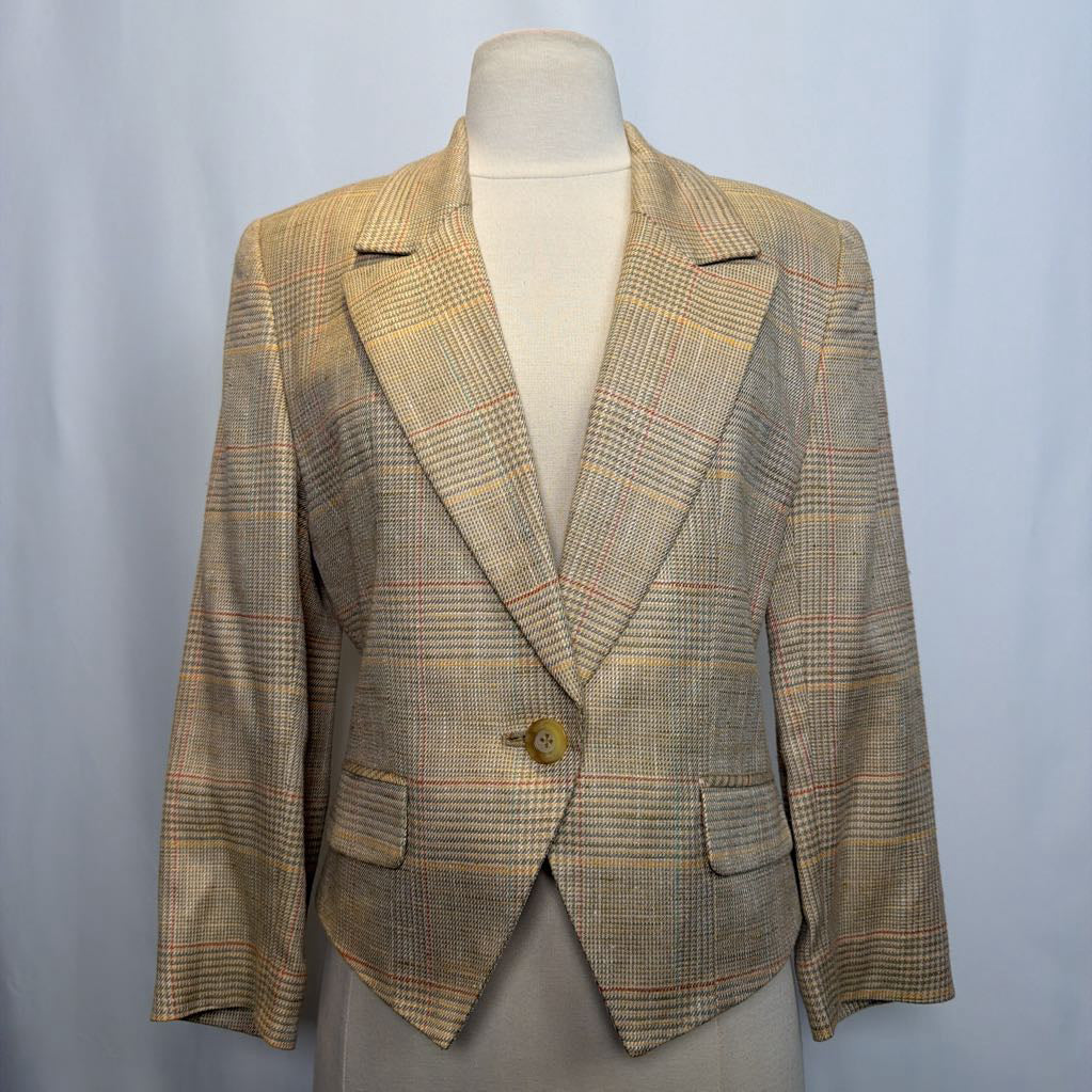 Plaid blazer on a mannequin against a plain background