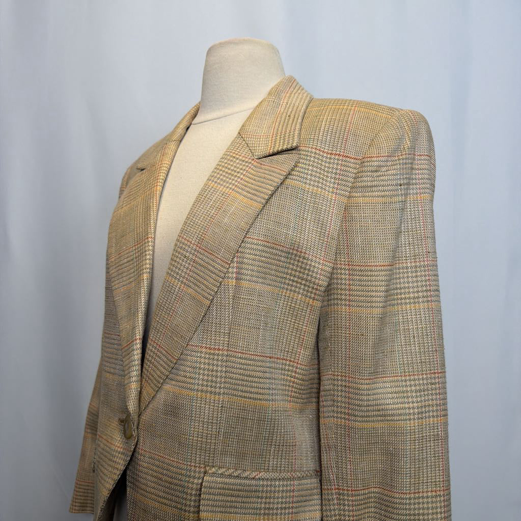 Plaid blazer on a mannequin against a plain background