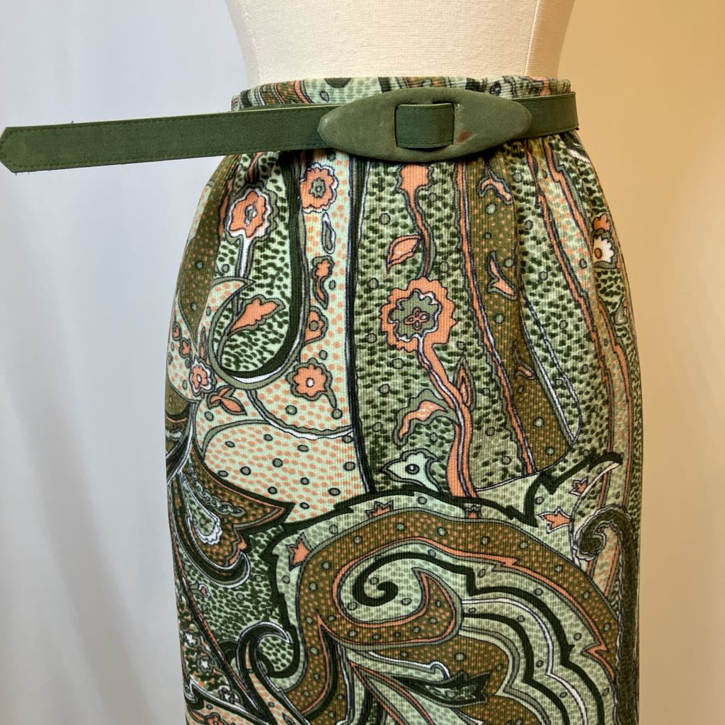 Patterned skirt with a belt on a mannequin against a neutral background