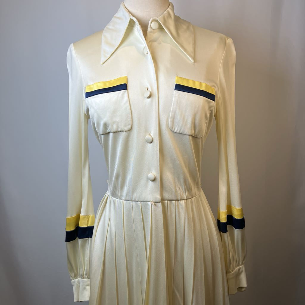 Vintage dress with yellow and blue accents on a plain background