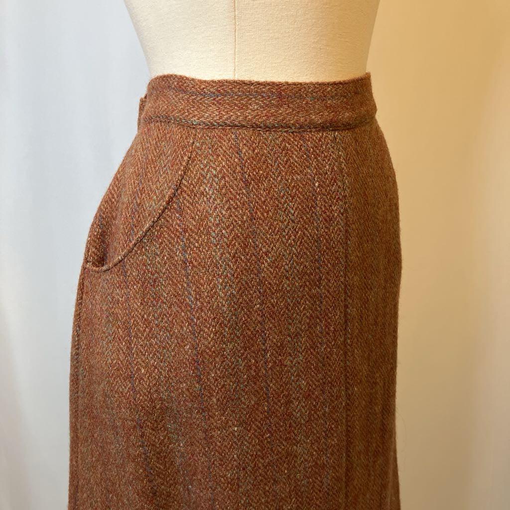 Brown tweed skirt on a mannequin against a plain background