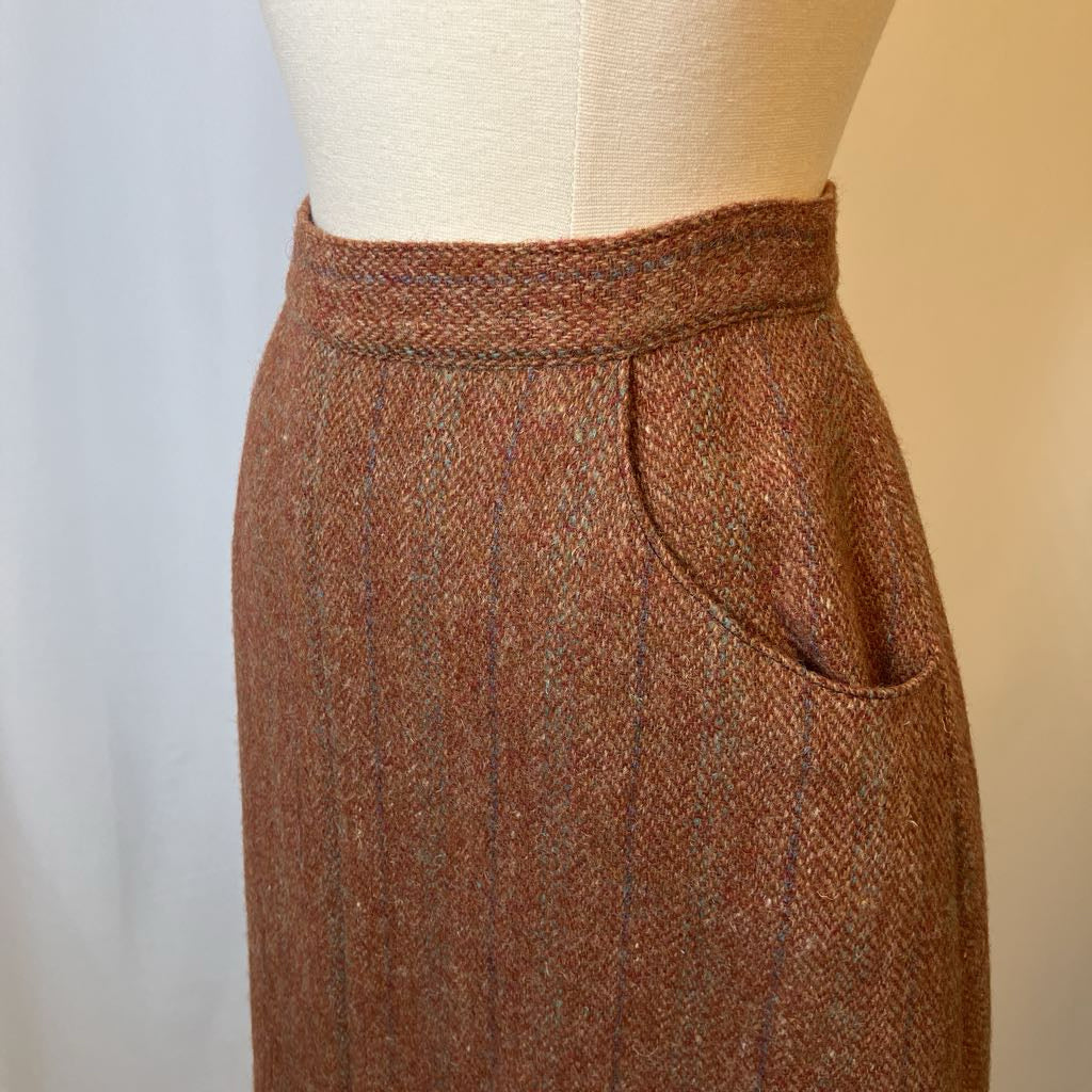 Brown tweed skirt on a mannequin against a neutral background