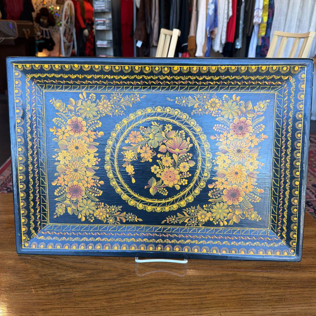 Decorative box with floral patterns on a wooden surface