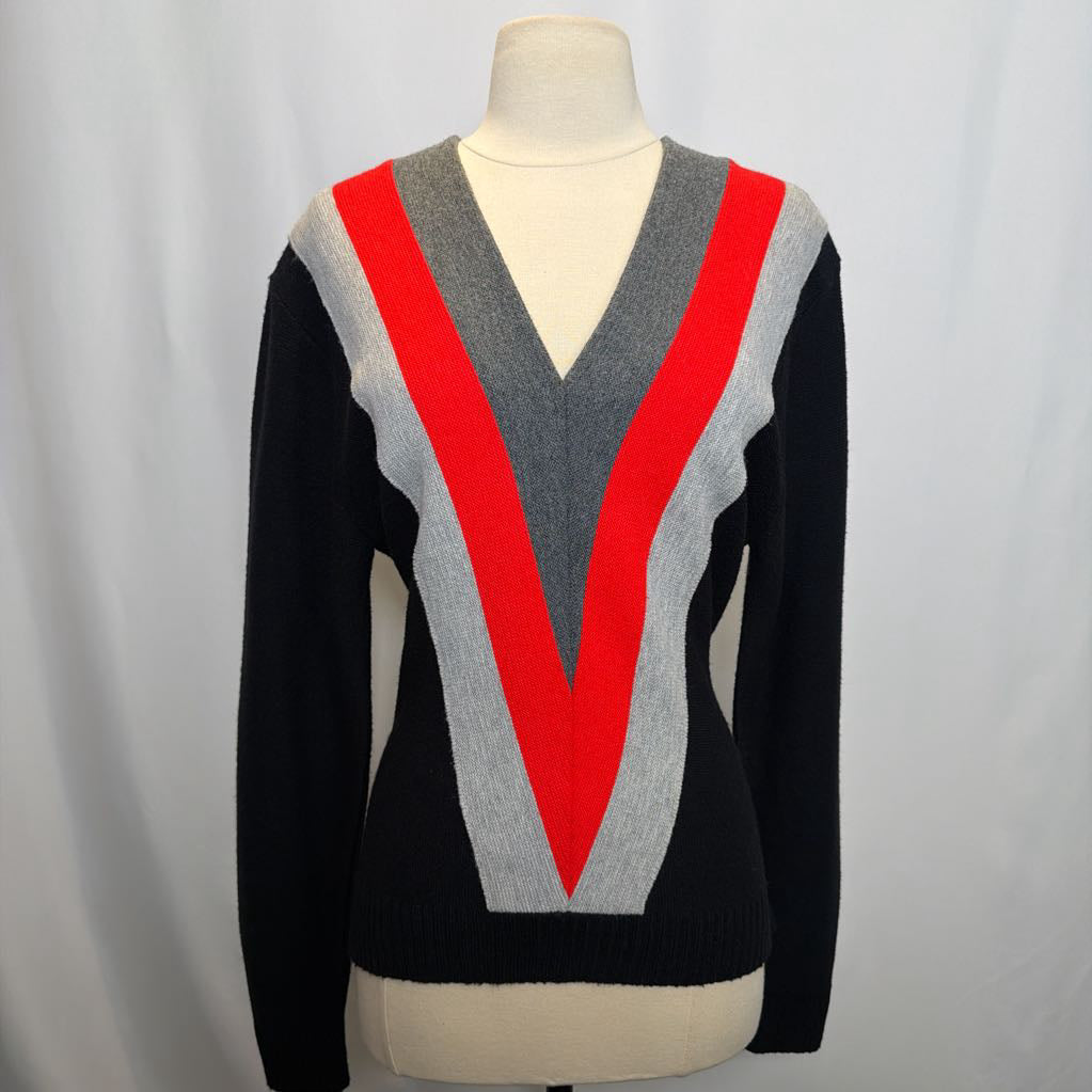 Sweater with a V-neck design featuring black, gray, and red colors on a mannequin against a plain background.