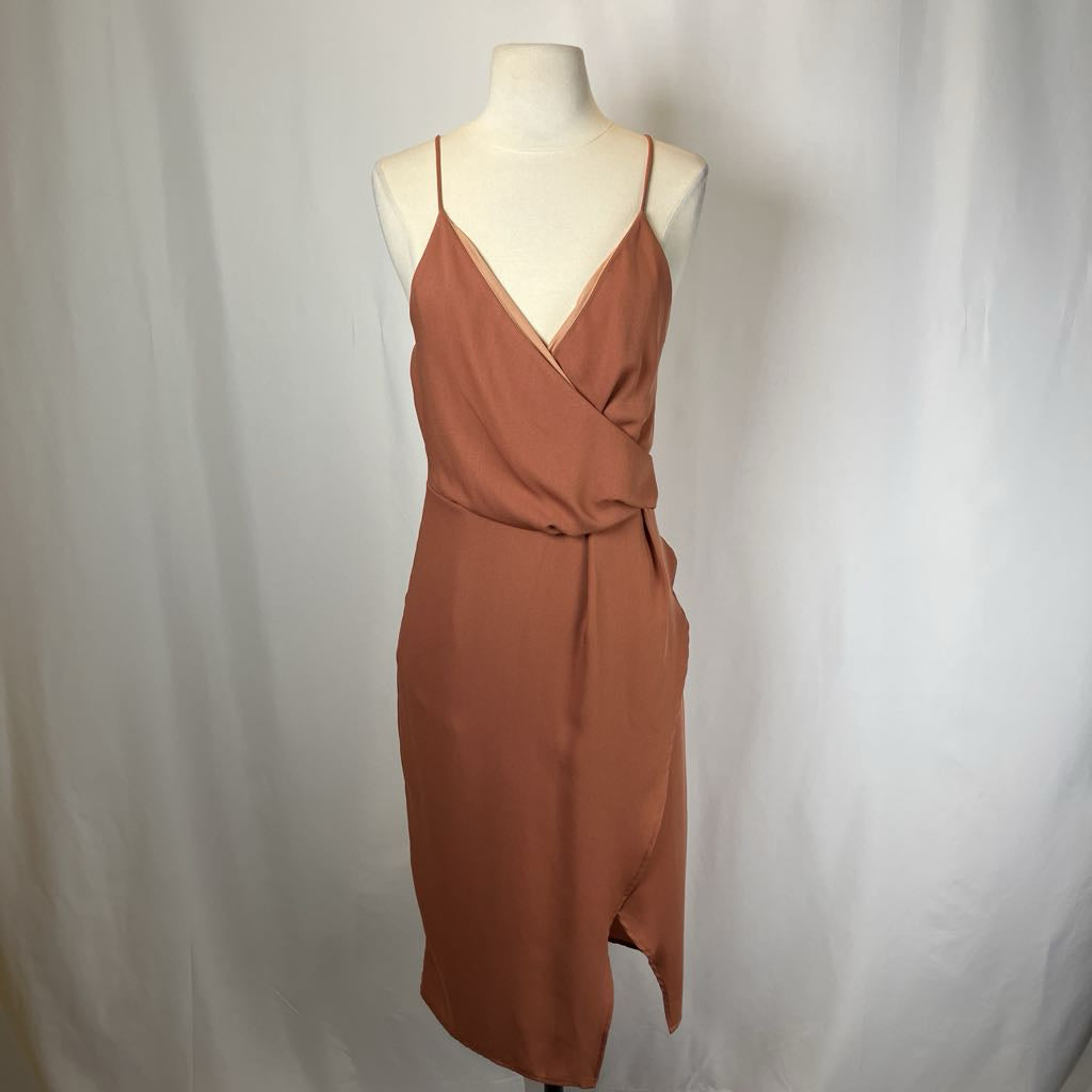 Brown dress on a mannequin against a plain background