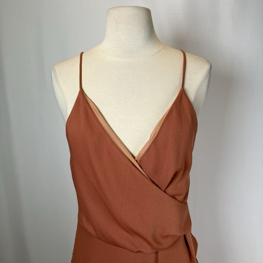 Brown dress on a mannequin against a plain background