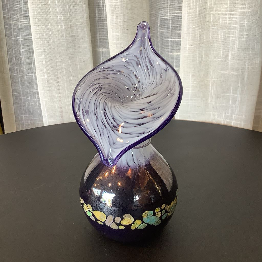 Decorative glass vase with a unique design on a dark surface