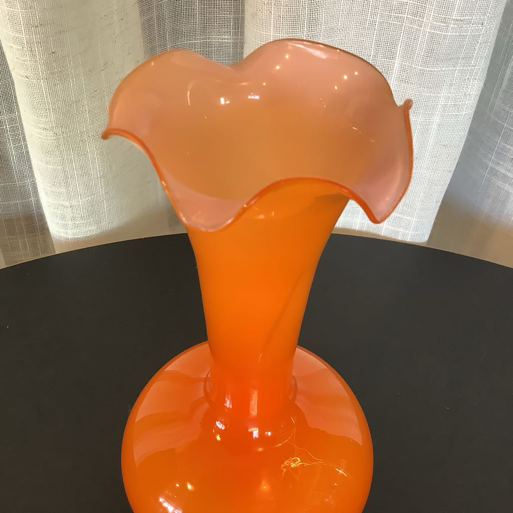 Orange glass vase with a textured background