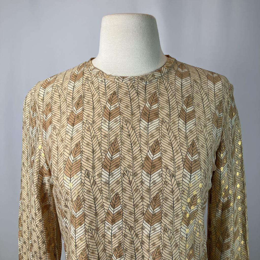 Mannequin wearing a patterned beige sweater against a plain background