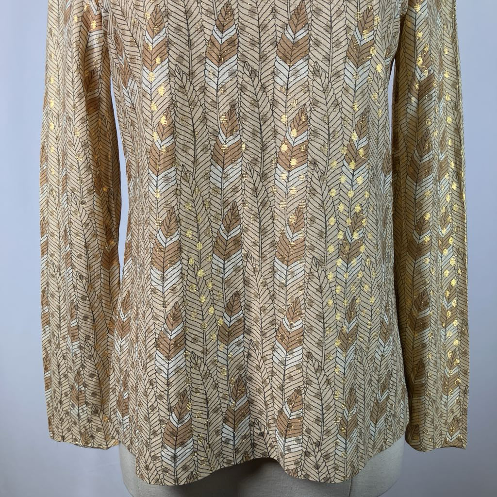 Mannequin wearing a patterned beige sweater against a plain background