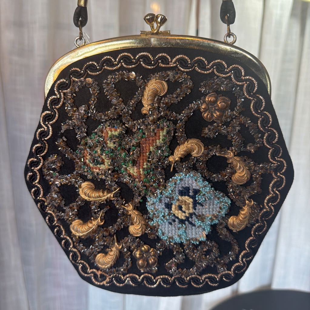Decorative handbag with intricate beadwork and embroidery on a white background