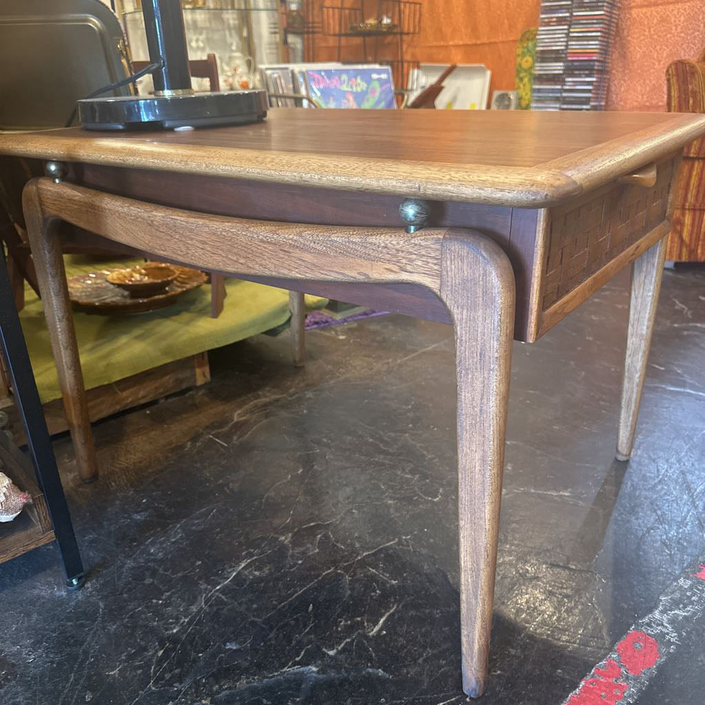 Wooden desk with a chair on a black marble floor