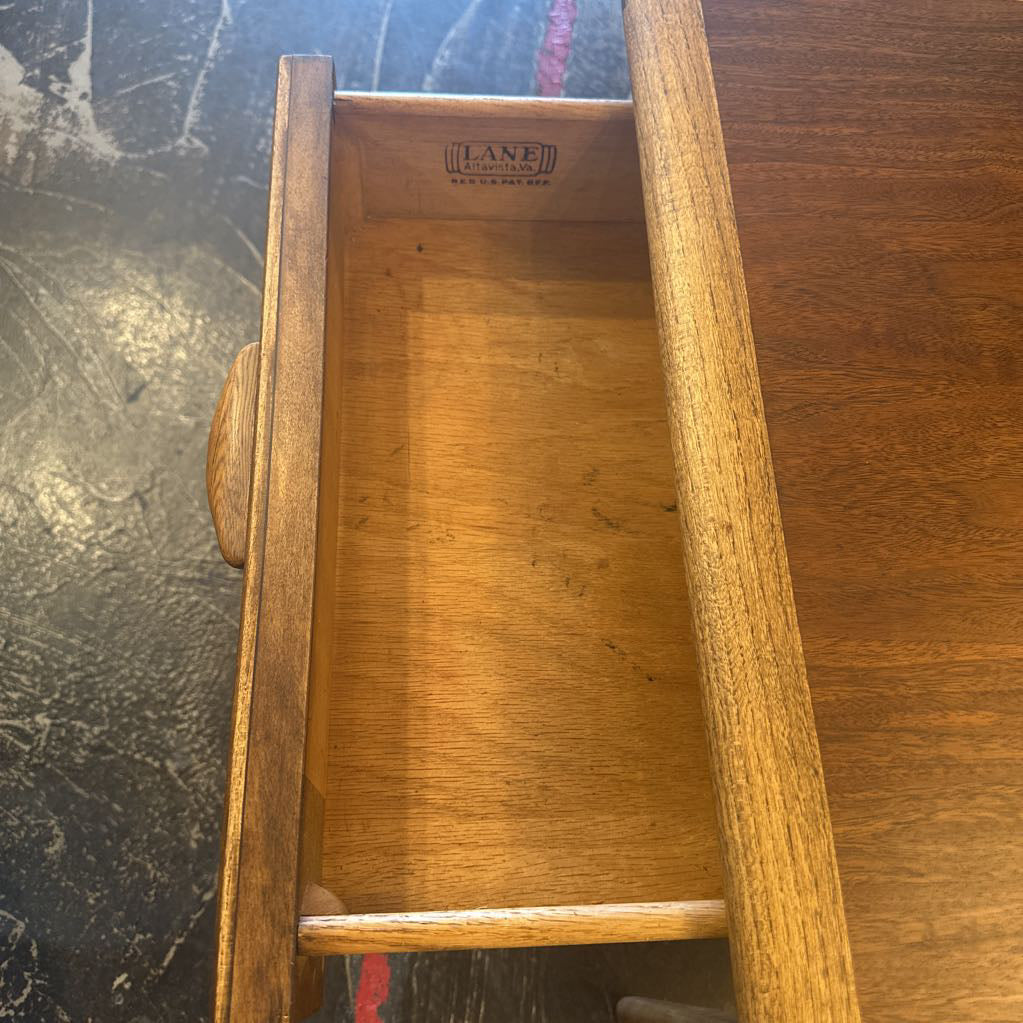 Wooden drawer with 'Lane' branding on a dark surface